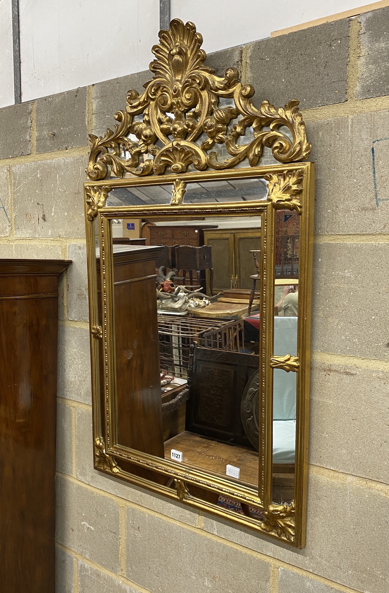 An 18th century style gilt composition wall mirror, width 62cm, height 106cm